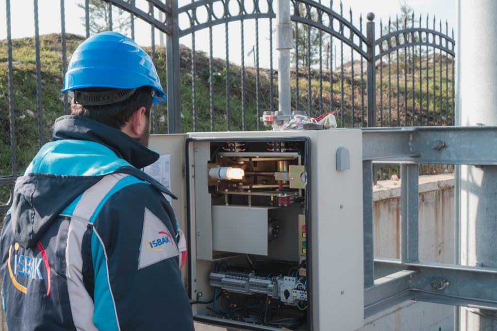 An Electrician Inspecting a Fuse Box